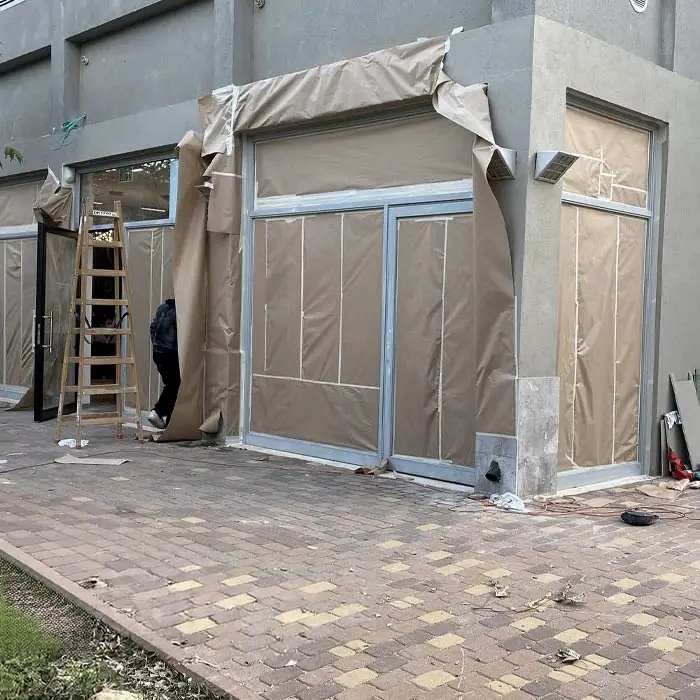 Storefront frames masked before painting